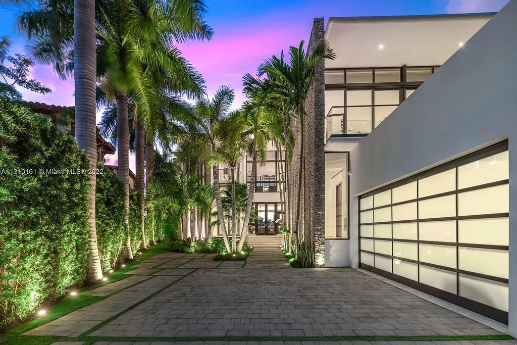 This stunning Venetian Island waterfront home located 420 W Rivo Alto Dr, Miami Beach, FL, boasts luxurious finishes. The tropical modern residence showcases a series of architectural scenes with seamless indoor-outdoor living, incorporating natural elements and offering breathtaking wide bay westerly sunsets