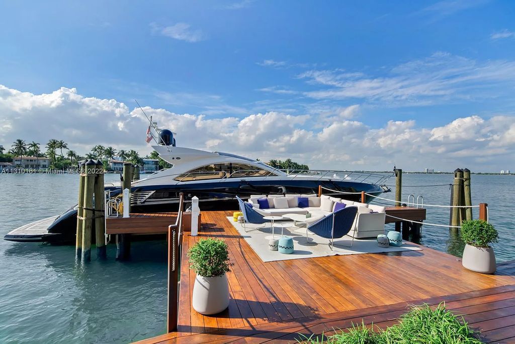 This stunning Venetian Island waterfront home located 420 W Rivo Alto Dr, Miami Beach, FL, boasts luxurious finishes. The tropical modern residence showcases a series of architectural scenes with seamless indoor-outdoor living, incorporating natural elements and offering breathtaking wide bay westerly sunsets