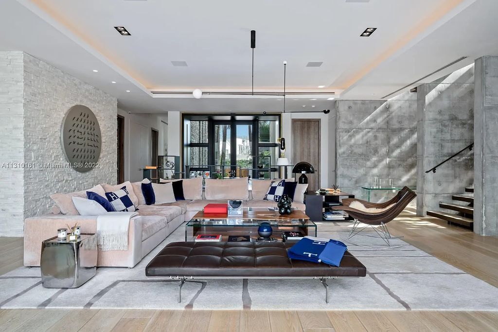 This stunning Venetian Island waterfront home located 420 W Rivo Alto Dr, Miami Beach, FL, boasts luxurious finishes. The tropical modern residence showcases a series of architectural scenes with seamless indoor-outdoor living, incorporating natural elements and offering breathtaking wide bay westerly sunsets