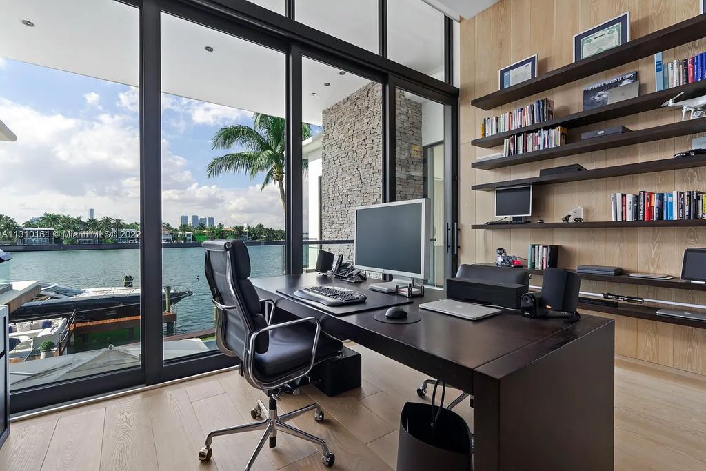 This stunning Venetian Island waterfront home located 420 W Rivo Alto Dr, Miami Beach, FL, boasts luxurious finishes. The tropical modern residence showcases a series of architectural scenes with seamless indoor-outdoor living, incorporating natural elements and offering breathtaking wide bay westerly sunsets