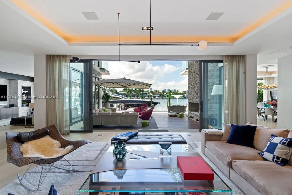 This stunning Venetian Island waterfront home located 420 W Rivo Alto Dr, Miami Beach, FL, boasts luxurious finishes. The tropical modern residence showcases a series of architectural scenes with seamless indoor-outdoor living, incorporating natural elements and offering breathtaking wide bay westerly sunsets