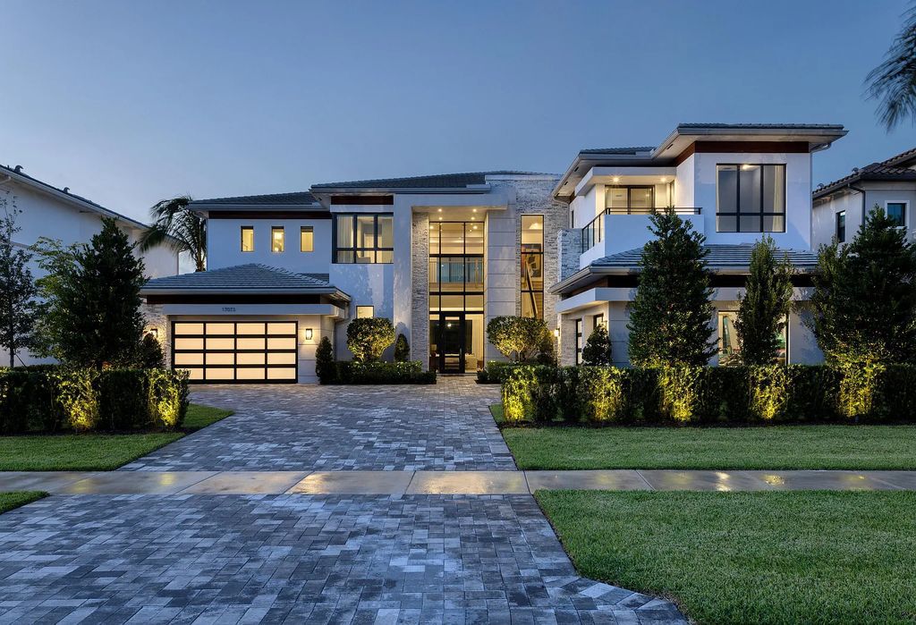 17073 Brulee Breeze Way, Boca Raton, Florida. This Vanderbilt Grand is the largest model offered in Boca Bridges and was constructed by the illustrious GL Homes in 2022. With over 8,179 square feet of luxurious living space, this majestic residence boasts six spacious bedrooms, eight bathrooms, a four-car garage, custom and upgraded accents, a resort-style pool, and an opulent outdoor living area. A fully furnished option is negotiable for this sprawling estate