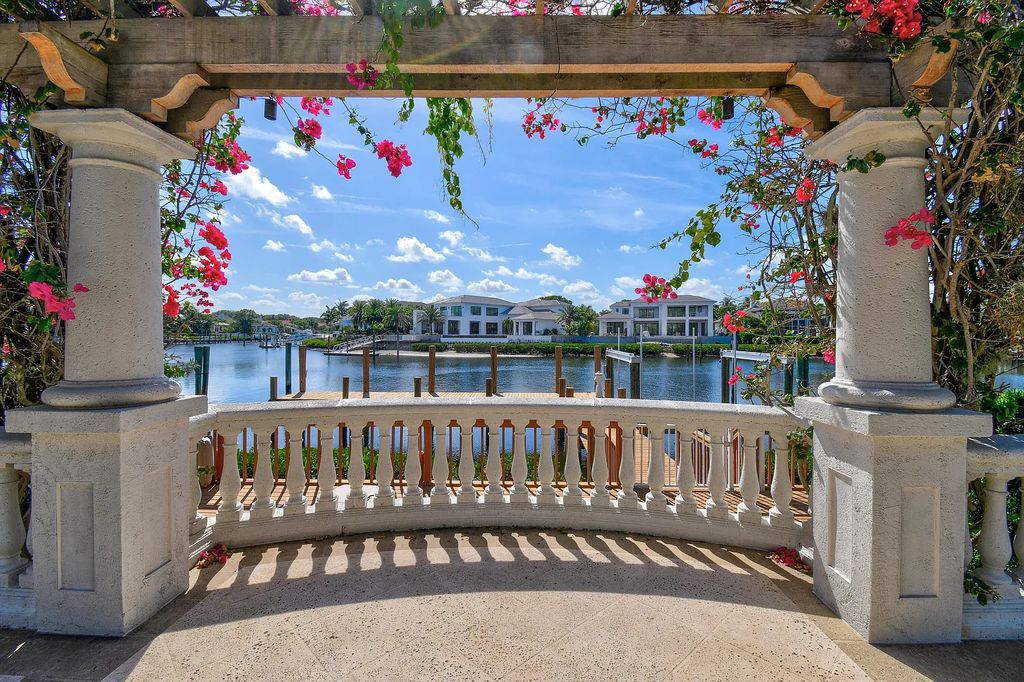 Outstanding custom estate located at 456 Mariner Dr, Jupiter, Florida, in the exclusive guard-gated community of Admirals Cove. It sits on 110' of waterfrontage with no fixed bridges. This timeless masterpiece features 5 BR/5.1 BA + an office, boasting 9,101 sq ft with soaring ceilings and spectacular water views from almost every room.