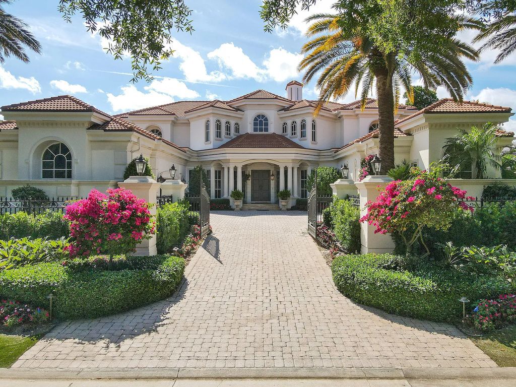 Outstanding custom estate located at 456 Mariner Dr, Jupiter, Florida, in the exclusive guard-gated community of Admirals Cove. It sits on 110' of waterfrontage with no fixed bridges. This timeless masterpiece features 5 BR/5.1 BA + an office, boasting 9,101 sq ft with soaring ceilings and spectacular water views from almost every room.