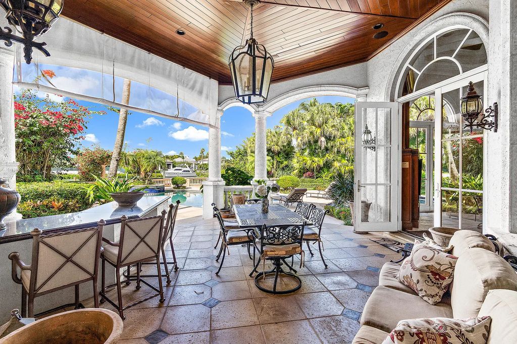 Outstanding custom estate located at 456 Mariner Dr, Jupiter, Florida, in the exclusive guard-gated community of Admirals Cove. It sits on 110' of waterfrontage with no fixed bridges. This timeless masterpiece features 5 BR/5.1 BA + an office, boasting 9,101 sq ft with soaring ceilings and spectacular water views from almost every room.