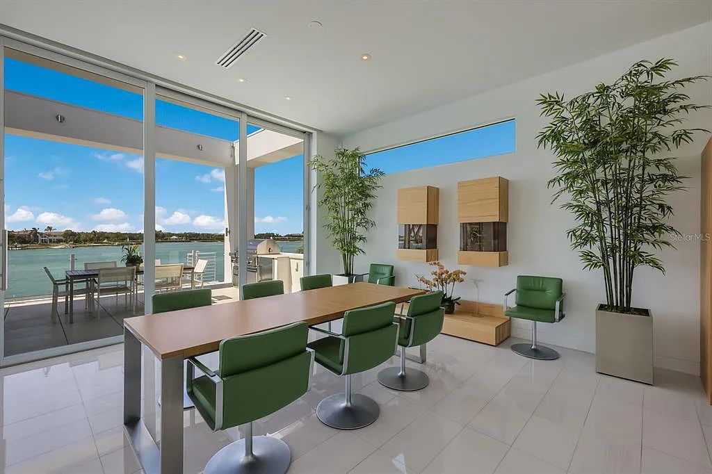 1325 Westway Dr, Sarasota, FL - A modern marvel overlooking New Pass in Lido Shores! Step into this tropical escape through the hidden courtyard that connects the three-bedroom main home to the secluded, two-bedroom guest house. The property features an expansive sundeck, a 60-foot wet-edge lap pool lined with royal palms and adorned with unique fire bowls. This serves as the perfect introduction to a contemporary masterpiece designed by DSDG Architect Mark Sultana and built by Voigt Brothers Construction.