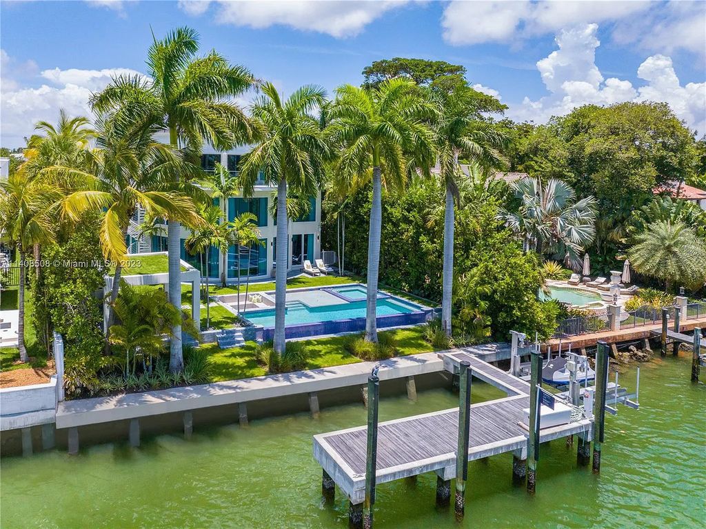 5785 Pine Tree Drive, Miami Beach, Florida, is a new Neo-Classic, one-of-a-kind, three-story waterfront home. It is fully furnished, equipped, and adorned by Argent Design. The house features an open atrium entry with water features and glass, as well as a stunning circular glass centerpiece staircase that stands 30 feet tall with a curved handrail. The living area spans an impressive 15,000 square feet, offering eight bedrooms, six full bathrooms, and two half bathrooms. The kitchen boasts large touch sensor cabinets.