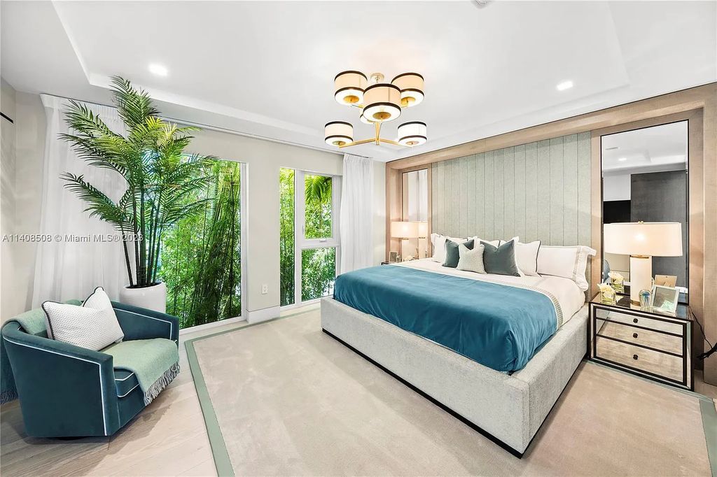 5785 Pine Tree Drive, Miami Beach, Florida, is a new Neo-Classic, one-of-a-kind, three-story waterfront home. It is fully furnished, equipped, and adorned by Argent Design. The house features an open atrium entry with water features and glass, as well as a stunning circular glass centerpiece staircase that stands 30 feet tall with a curved handrail. The living area spans an impressive 15,000 square feet, offering eight bedrooms, six full bathrooms, and two half bathrooms. The kitchen boasts large touch sensor cabinets.