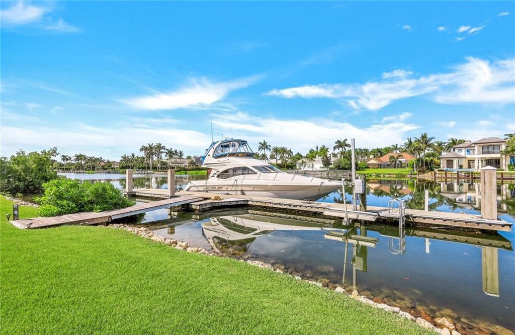 1030 Galleon Drive, Naples, Florida. An impressive and beautiful custom home sits on an oversized lot, boasting 0.8 acres which equals one and a half Port Royal lots. With over 160 feet of water frontage, this luxury residence is situated on Galleon Drive, in one of the most sought-after locations in Naples, FL. This exquisite home features five bedrooms, seven bathrooms, an office/den, a sauna, an elevator, and multiple balconies on the second floor, offering breathtaking water and sunset views. It provides a high level of privacy, making it truly exceptional.