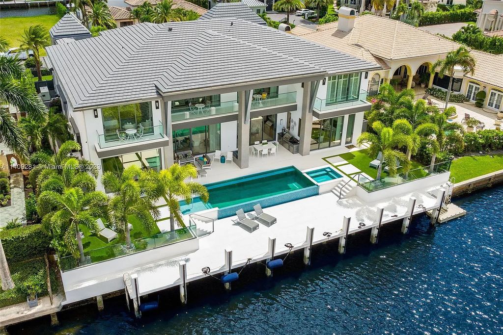 Welcome to 169 W. Key Palm Road in Boca Raton, a visionary display of architectural intrigue and soft contemporary design. The waterfront property is situated behind private gates in one of the most prominent residential communities in all of South Florida—Royal Palm Yacht & Country Club