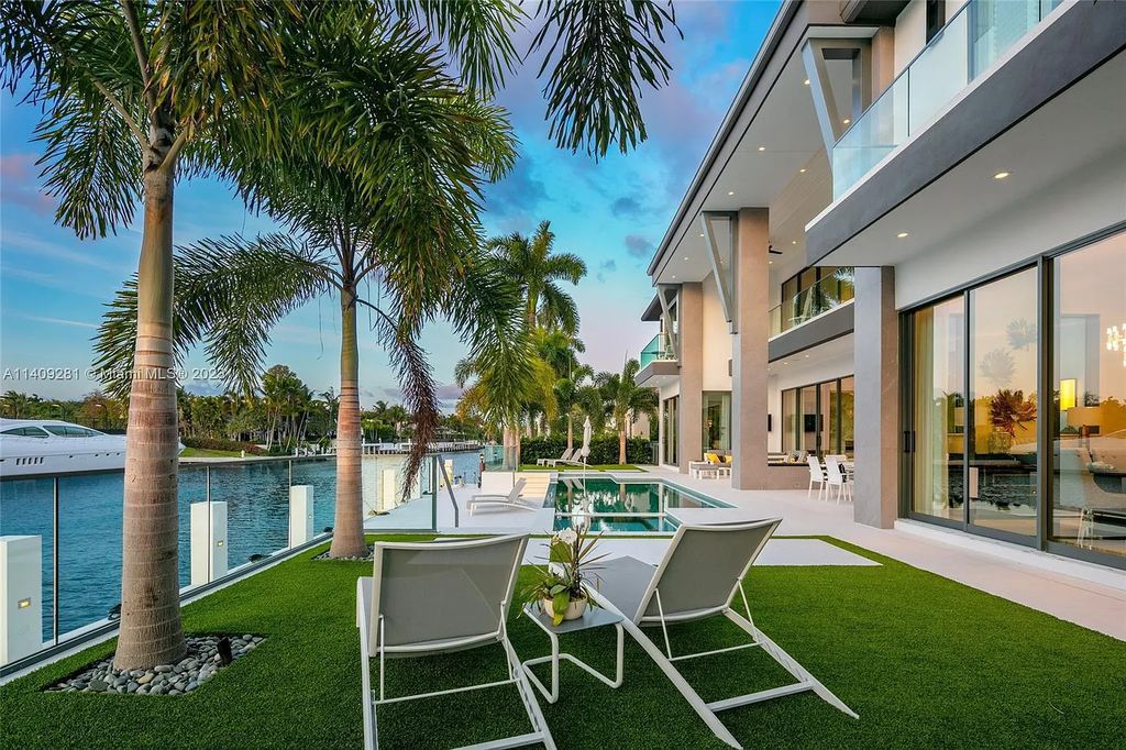 Welcome to 169 W. Key Palm Road in Boca Raton, a visionary display of architectural intrigue and soft contemporary design. The waterfront property is situated behind private gates in one of the most prominent residential communities in all of South Florida—Royal Palm Yacht & Country Club