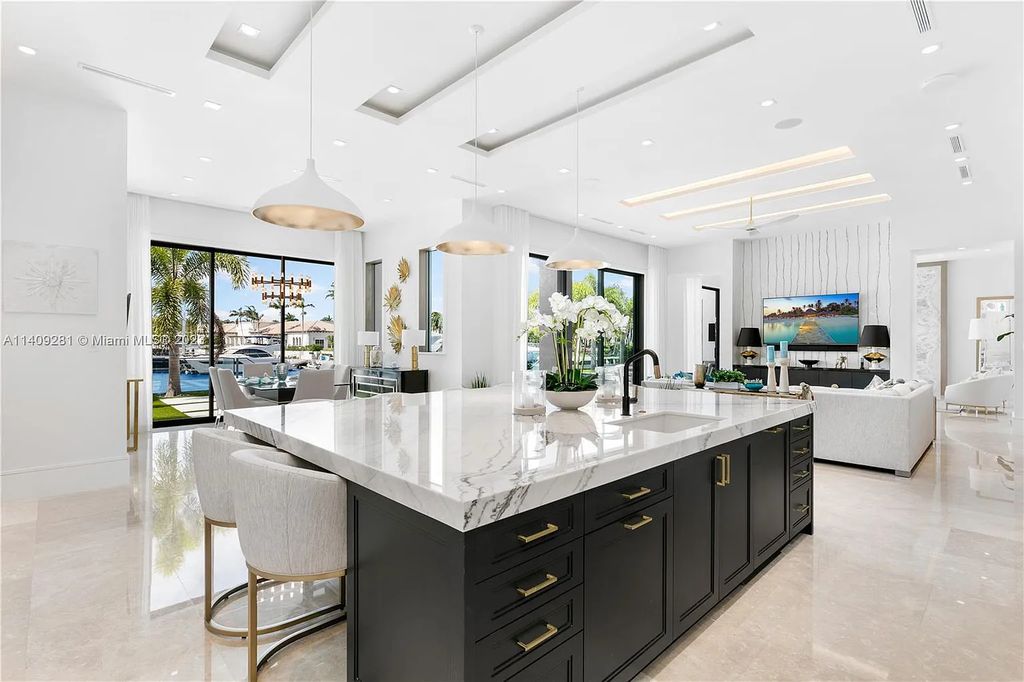 Welcome to 169 W. Key Palm Road in Boca Raton, a visionary display of architectural intrigue and soft contemporary design. The waterfront property is situated behind private gates in one of the most prominent residential communities in all of South Florida—Royal Palm Yacht & Country Club