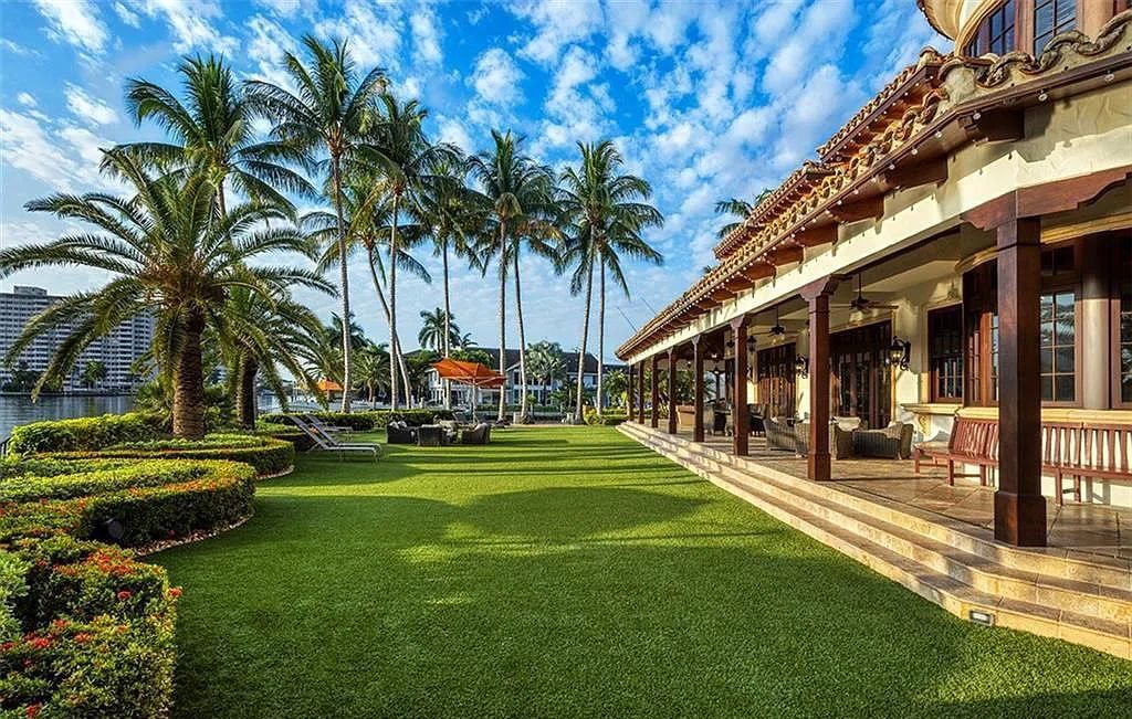 Located at 2900 NE 37th St, Fort Lauderdale, Florida, this gated palatial Palm Beach-inspired point estate is situated in the prestigious Coral Ridge Country Club enclave, spanning over 1.09 acres (+/-) and surrounded by three astonishing sides of wrap-around waterfront, amounting to an impressive 665 feet (+/-) of full-service mega-yacht dockage.