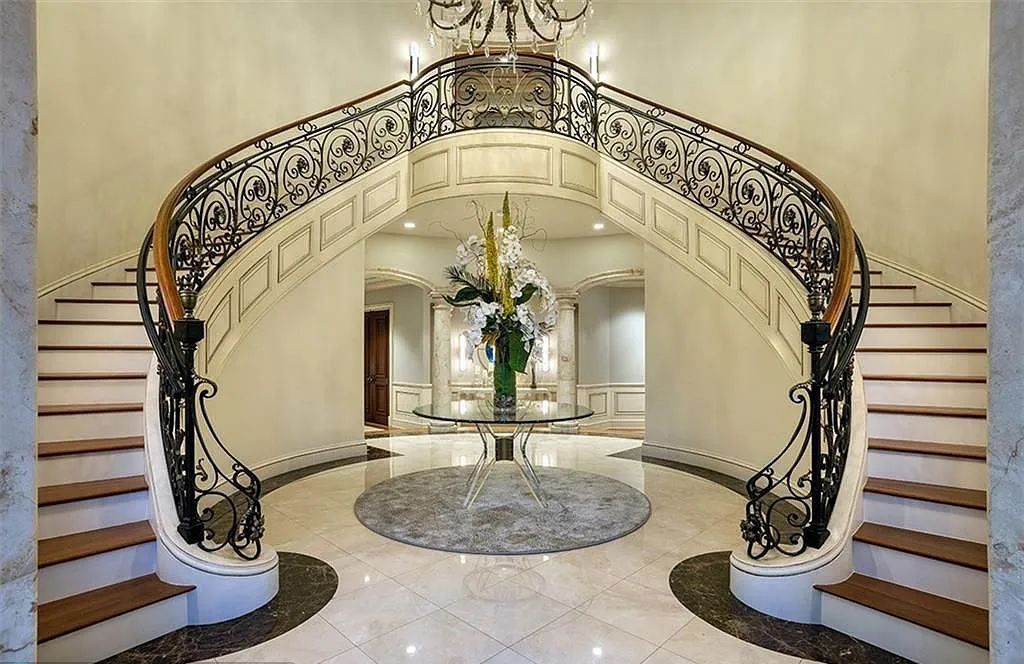 Located at 2900 NE 37th St, Fort Lauderdale, Florida, this gated palatial Palm Beach-inspired point estate is situated in the prestigious Coral Ridge Country Club enclave, spanning over 1.09 acres (+/-) and surrounded by three astonishing sides of wrap-around waterfront, amounting to an impressive 665 feet (+/-) of full-service mega-yacht dockage.