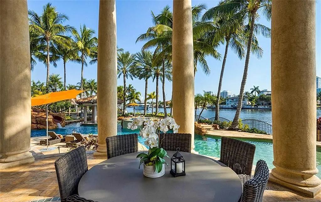 Located at 2900 NE 37th St, Fort Lauderdale, Florida, this gated palatial Palm Beach-inspired point estate is situated in the prestigious Coral Ridge Country Club enclave, spanning over 1.09 acres (+/-) and surrounded by three astonishing sides of wrap-around waterfront, amounting to an impressive 665 feet (+/-) of full-service mega-yacht dockage.