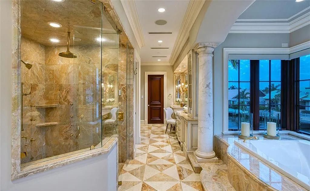 Located at 2900 NE 37th St, Fort Lauderdale, Florida, this gated palatial Palm Beach-inspired point estate is situated in the prestigious Coral Ridge Country Club enclave, spanning over 1.09 acres (+/-) and surrounded by three astonishing sides of wrap-around waterfront, amounting to an impressive 665 feet (+/-) of full-service mega-yacht dockage.