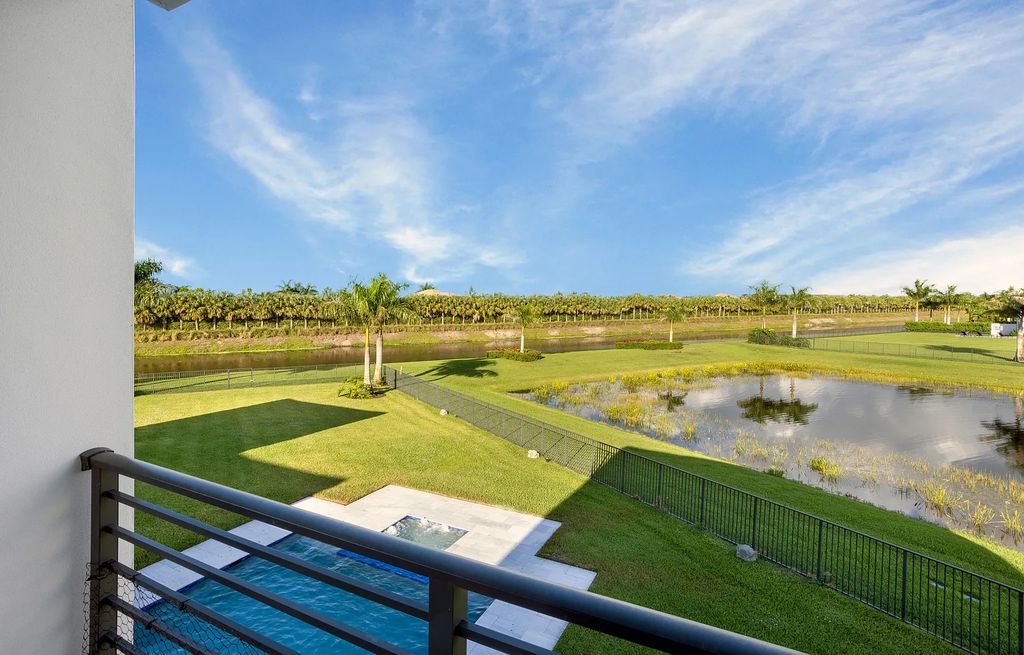 17055 Brulee Breeze Way, Boca Raton, Florida Quietly tucked away in a private cul-de-sac and nestled on an oversized 0.72 +- acre lot, this coveted Vanderbilt Grand Contemporary model spans 11,873 +- square feet of exquisite living. Featuring six commodious bedrooms, eight full and two partial bathrooms, four car garage, custom and upgraded accents, and luxuriant outdoor living space, this sprawling pristine lakefront estate was constructed by the prestigious GL Homes in 2020 and is the largest model offered at Boca Bridges.