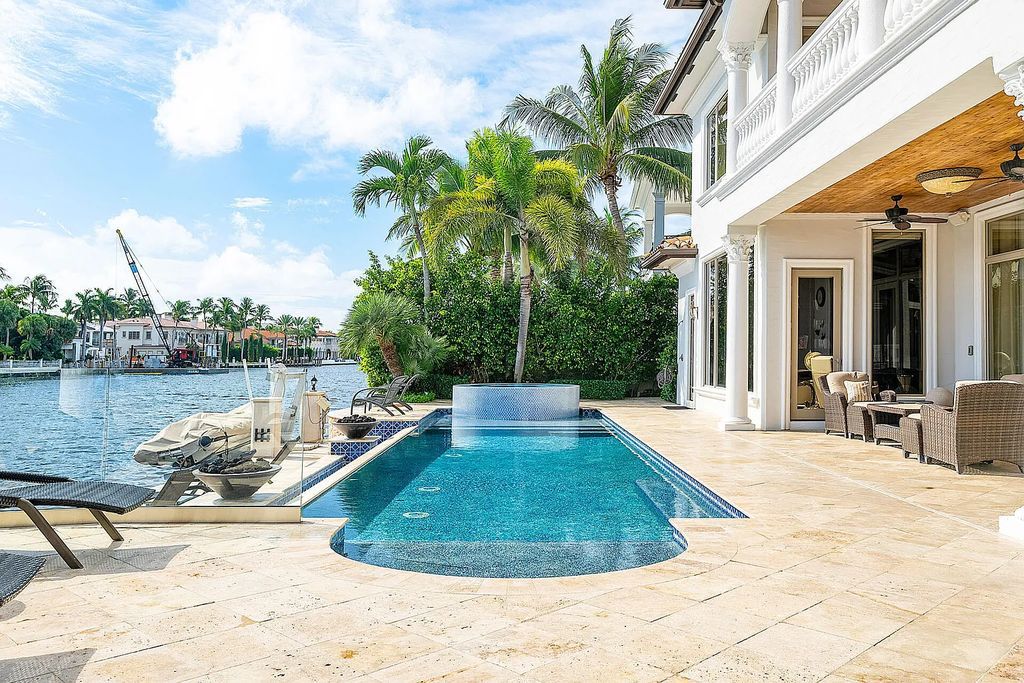 Live the ultimate waterfront dream at this exquisite estate in the prestigious Royal Palm Yacht & Country Club. With its private dock, resort-style pool, and awe-inspiring vistas, this 5-bedroom home offers the perfect blend of luxury and serenity.