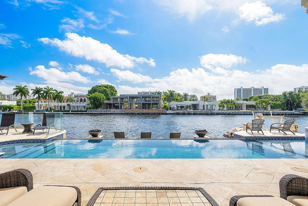 Live the ultimate waterfront dream at this exquisite estate in the prestigious Royal Palm Yacht & Country Club. With its private dock, resort-style pool, and awe-inspiring vistas, this 5-bedroom home offers the perfect blend of luxury and serenity.