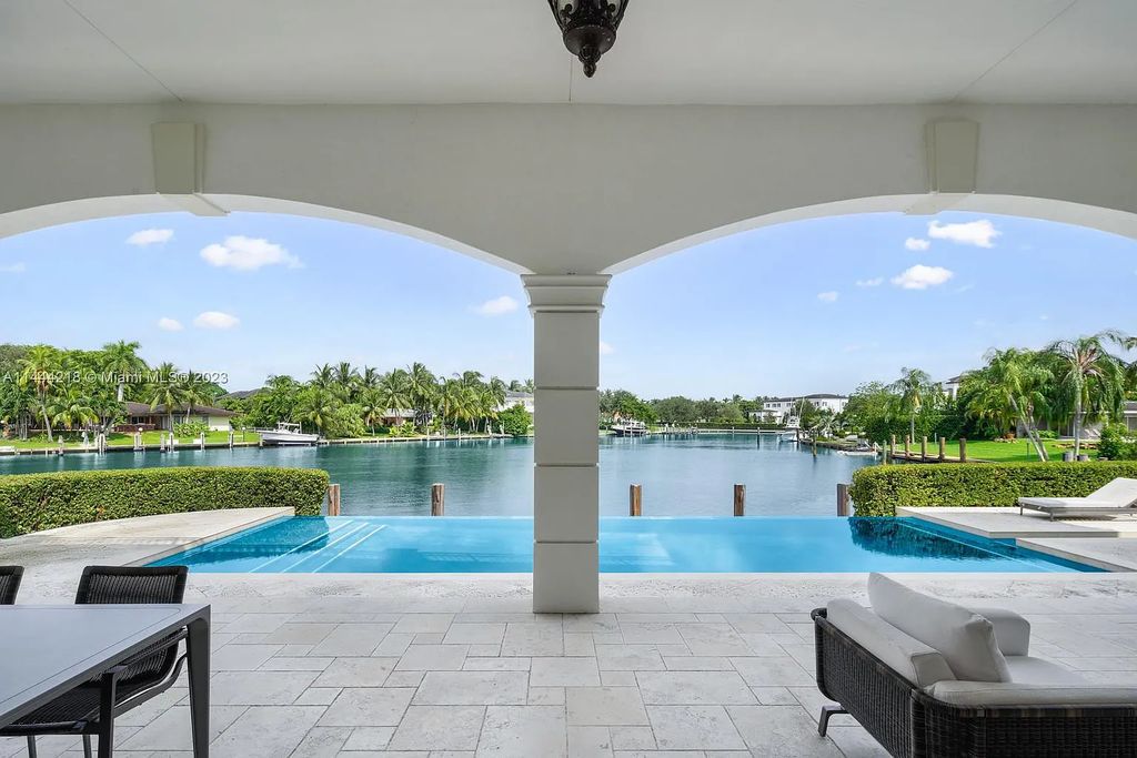 This architectural masterpiece, designed by famed architect Ramon Pacheco and remodeled in 2015, offers modern luxury living in the highly coveted & gated Coral Gables community of Old Cutler Bay. The grand foyer, sweeping staircase, and soaring ceilings welcome an abundance of natural light and elegance. Complete with an infinity-edge pool, plenty of covered terraces, and beautiful water views.