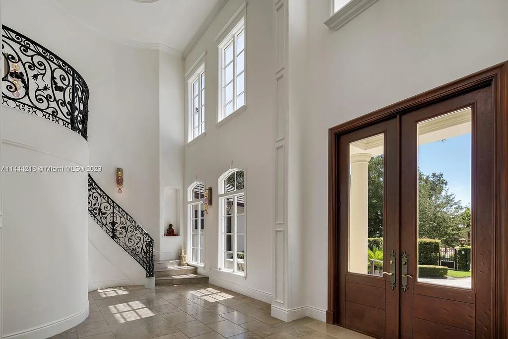 This architectural masterpiece, designed by famed architect Ramon Pacheco and remodeled in 2015, offers modern luxury living in the highly coveted & gated Coral Gables community of Old Cutler Bay. The grand foyer, sweeping staircase, and soaring ceilings welcome an abundance of natural light and elegance. Complete with an infinity-edge pool, plenty of covered terraces, and beautiful water views.