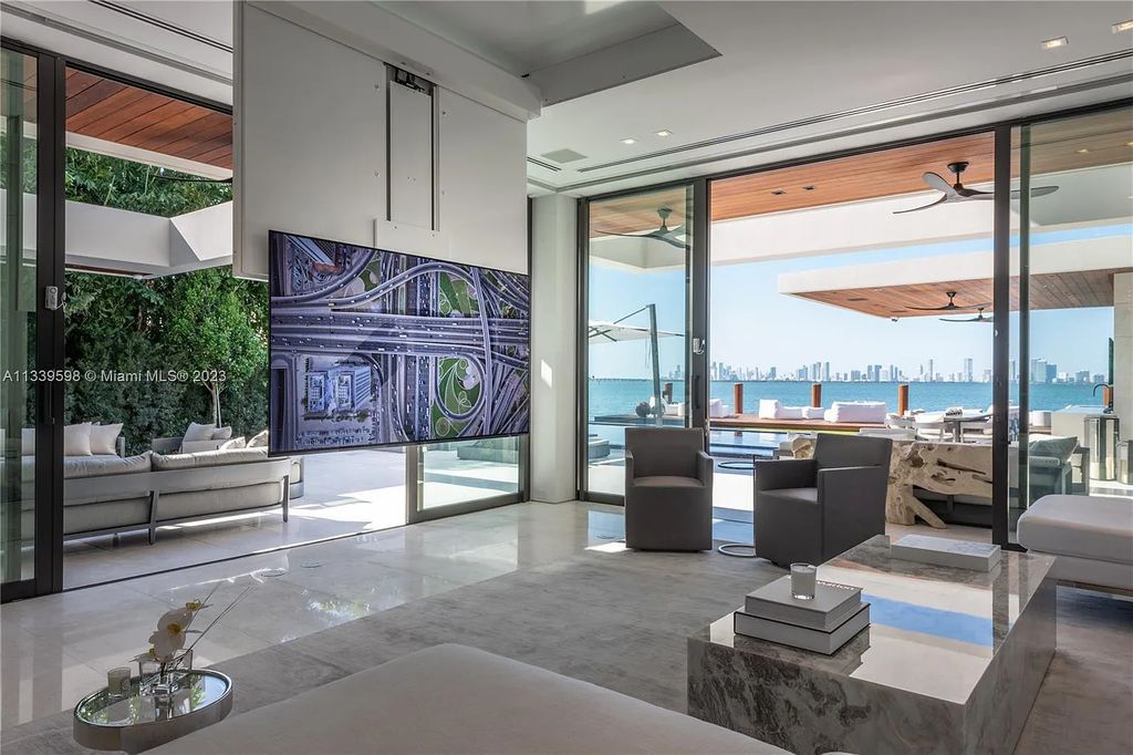 This luxurious waterfront residence in Miami Beach is the ultimate in luxury living. With 7 bedrooms, 7 bathrooms, and 2 half baths, this home has plenty of space for everyone. Enjoy stunning views of the city from the rooftop terrace, or relax in the heated saltwater pool and spa. This private gated property also has a boat dock and 70 feet of waterfront.