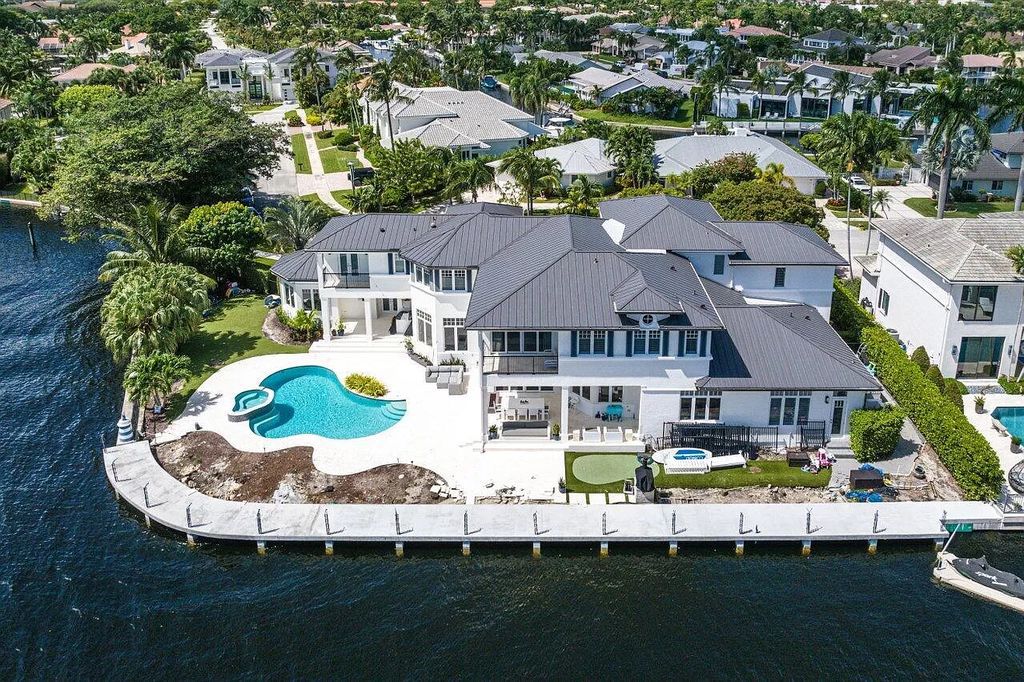 This spectacular waterfront masterpiece in Boca Bay Colony features 6 bedrooms, 8 baths, 7,282 sq ft, 265 ft of water frontage, and a deepwater dock that can accommodate a mega yacht. The chef-designed kitchen, home theater, 400-bottle wine cellar, and expansive backyard with pool, summer kitchen, and pergola offer endless possibilities for relaxation and entertainment. Schedule your private showing today!