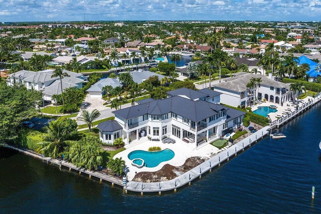 This spectacular waterfront masterpiece in Boca Bay Colony features 6 bedrooms, 8 baths, 7,282 sq ft, 265 ft of water frontage, and a deepwater dock that can accommodate a mega yacht. The chef-designed kitchen, home theater, 400-bottle wine cellar, and expansive backyard with pool, summer kitchen, and pergola offer endless possibilities for relaxation and entertainment. Schedule your private showing today!