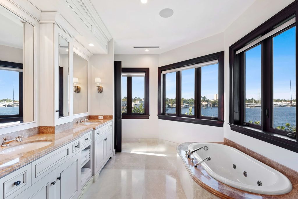 This luxurious estate in the exclusive Sunrise Key neighborhood of Fort Lauderdale offers stunning river views, a coveted point lot location, and high-end finishes throughout. The main house features marble floors, soaring ceilings, floor-to-ceiling windows, and an open floor plan perfect for entertaining.