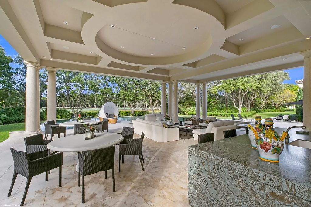 This custom Palladian-styled estate residence in Jupiter, FL offers 33,705 total square feet with 7 bedrooms, 9 baths and 3 half baths, stunning views of the Nicklaus signature golf course, and bespoke finishes throughout. The property also includes a spacious free-standing office and a separate two-story guest house.