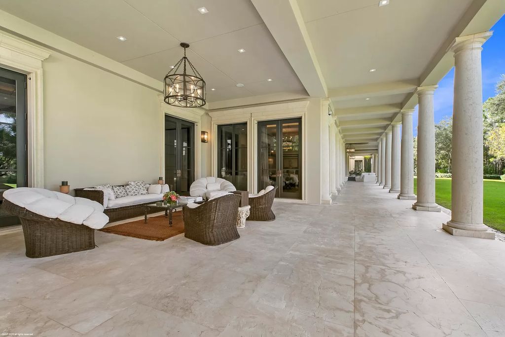 This custom Palladian-styled estate residence in Jupiter, FL offers 33,705 total square feet with 7 bedrooms, 9 baths and 3 half baths, stunning views of the Nicklaus signature golf course, and bespoke finishes throughout. The property also includes a spacious free-standing office and a separate two-story guest house.