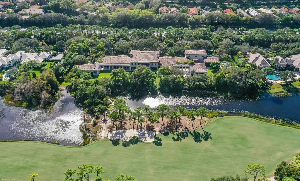 This custom Palladian-styled estate residence in Jupiter, FL offers 33,705 total square feet with 7 bedrooms, 9 baths and 3 half baths, stunning views of the Nicklaus signature golf course, and bespoke finishes throughout. The property also includes a spacious free-standing office and a separate two-story guest house.