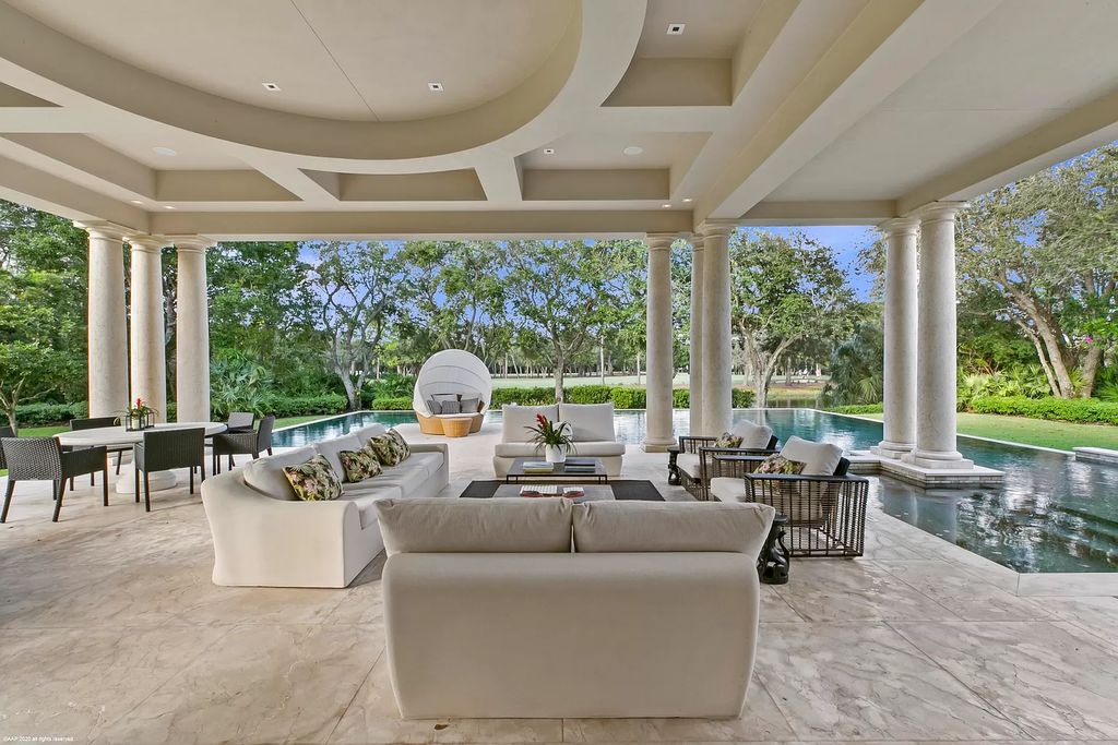 This custom Palladian-styled estate residence in Jupiter, FL offers 33,705 total square feet with 7 bedrooms, 9 baths and 3 half baths, stunning views of the Nicklaus signature golf course, and bespoke finishes throughout. The property also includes a spacious free-standing office and a separate two-story guest house.