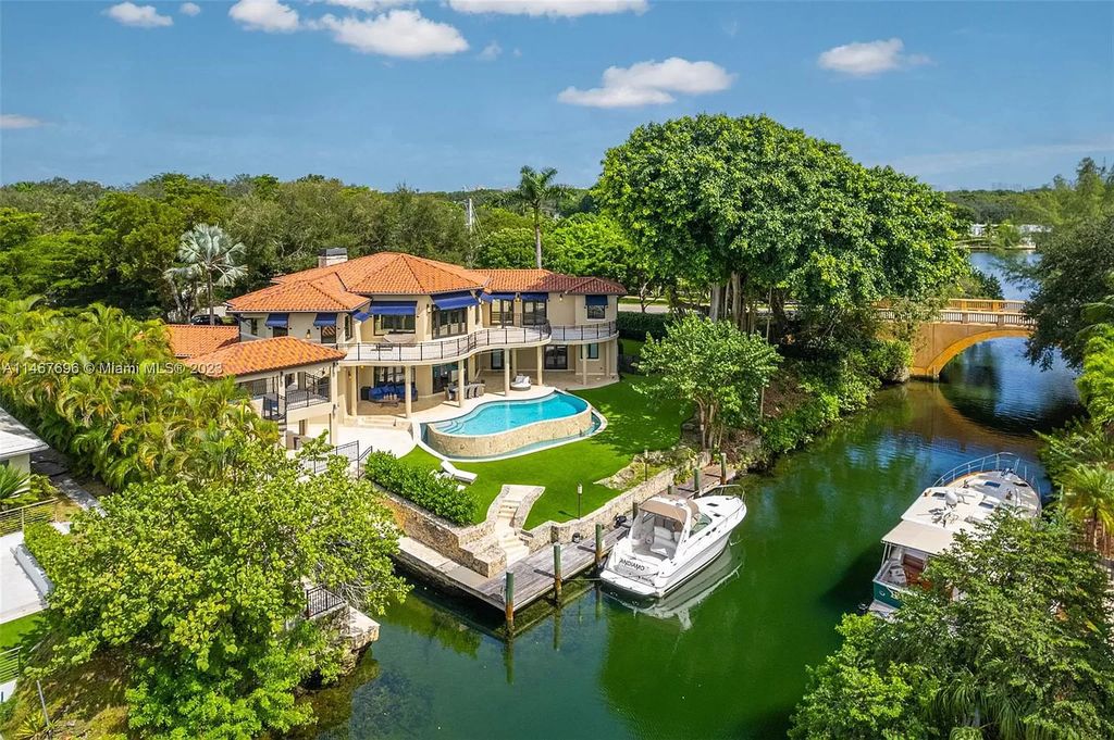 This idyllic waterfront estate in Coral Gables is situated on a peaceful double corner lot with 197' on the Mahi Waterway. It features two impressive master suites, a spacious loft, and breathtaking large living areas. The chef's kitchen features Wolf, Sub-Zero, True, Miele, Hoshizaki, and Eagle Group Commercial appliances. The exterior features a dual gas fireplace, fire magic summer kitchen, bar and lounge, pool, spa, and 60' dock with a rare grandfathered 40' boat slip.