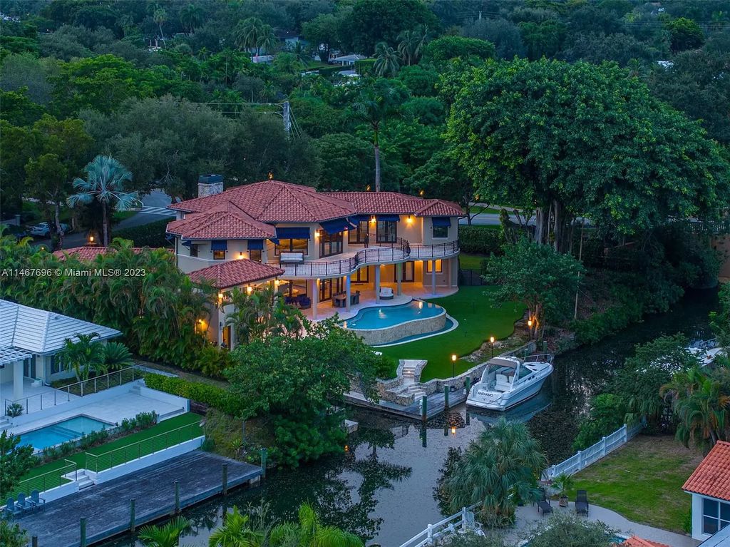 This idyllic waterfront estate in Coral Gables is situated on a peaceful double corner lot with 197' on the Mahi Waterway. It features two impressive master suites, a spacious loft, and breathtaking large living areas. The chef's kitchen features Wolf, Sub-Zero, True, Miele, Hoshizaki, and Eagle Group Commercial appliances. The exterior features a dual gas fireplace, fire magic summer kitchen, bar and lounge, pool, spa, and 60' dock with a rare grandfathered 40' boat slip.