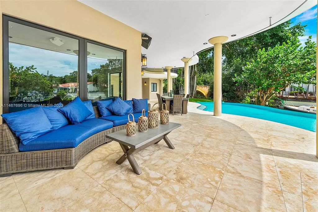 This idyllic waterfront estate in Coral Gables is situated on a peaceful double corner lot with 197' on the Mahi Waterway. It features two impressive master suites, a spacious loft, and breathtaking large living areas. The chef's kitchen features Wolf, Sub-Zero, True, Miele, Hoshizaki, and Eagle Group Commercial appliances. The exterior features a dual gas fireplace, fire magic summer kitchen, bar and lounge, pool, spa, and 60' dock with a rare grandfathered 40' boat slip.