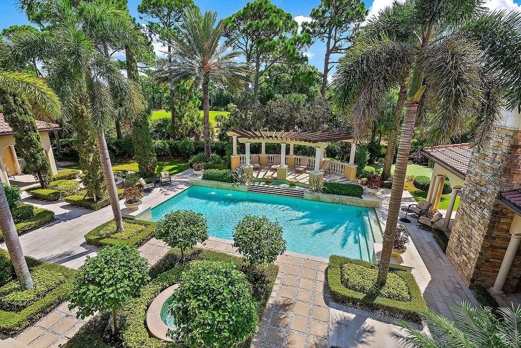 This stunning 5 bedroom, 7.5 bathroom Mediterranean villa is nestled on a private 3/4 acre lot in the prestigious Old Palm Golf Club community. With over 9,200 square feet of living space, this home boasts exceptional features such as a grand two story entry, high ceilings throughout, a spacious primary suite with dual luxury baths and sitting room, a game room, bar, wine room, chef's kitchen, and extended outdoor living space. Enjoy panoramic golf course views from the balconies or relax on the spacious paver patios with fountains. This home leaves nothing to be desired!