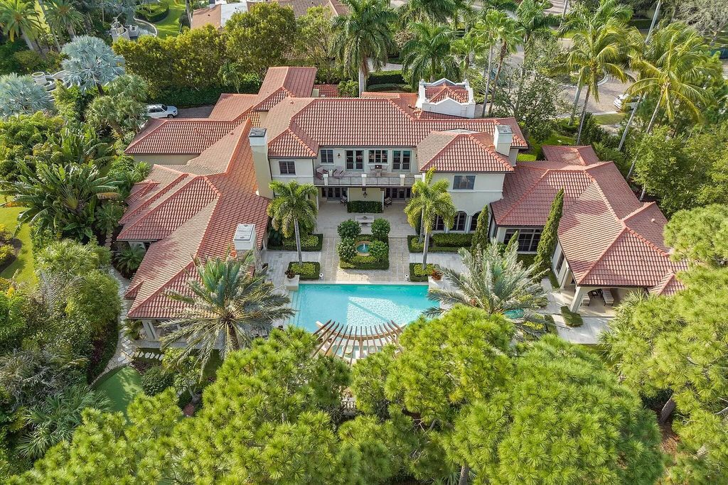 This stunning 5 bedroom, 7.5 bathroom Mediterranean villa is nestled on a private 3/4 acre lot in the prestigious Old Palm Golf Club community. With over 9,200 square feet of living space, this home boasts exceptional features such as a grand two story entry, high ceilings throughout, a spacious primary suite with dual luxury baths and sitting room, a game room, bar, wine room, chef's kitchen, and extended outdoor living space. Enjoy panoramic golf course views from the balconies or relax on the spacious paver patios with fountains. This home leaves nothing to be desired!