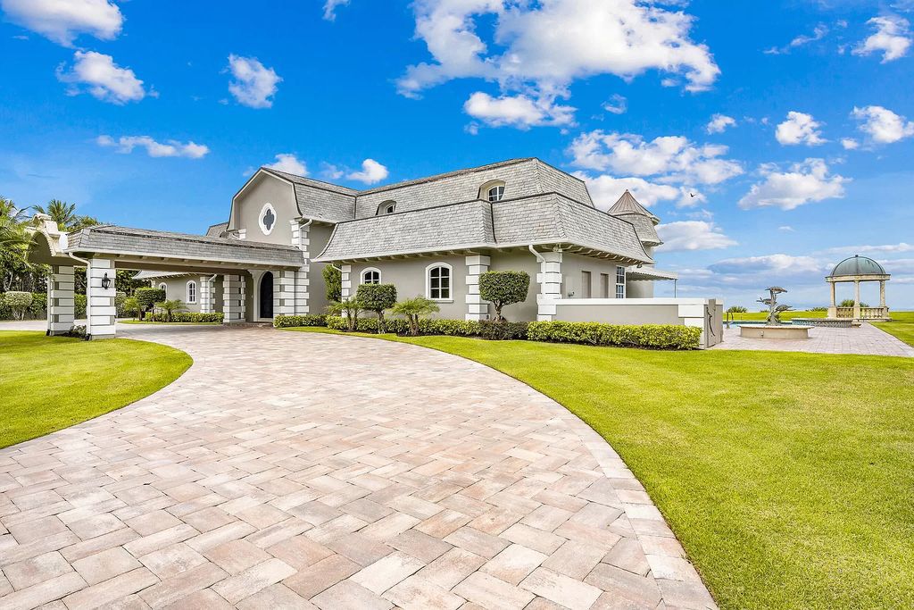 This captivating oceanfront estate on Jupiter Island offers 4 beds, 10 baths, and 2.62 acres of land with 242 feet of water frontage. Enjoy direct ocean views from every room in the house and spend your days swimming, sunbathing, and fishing.