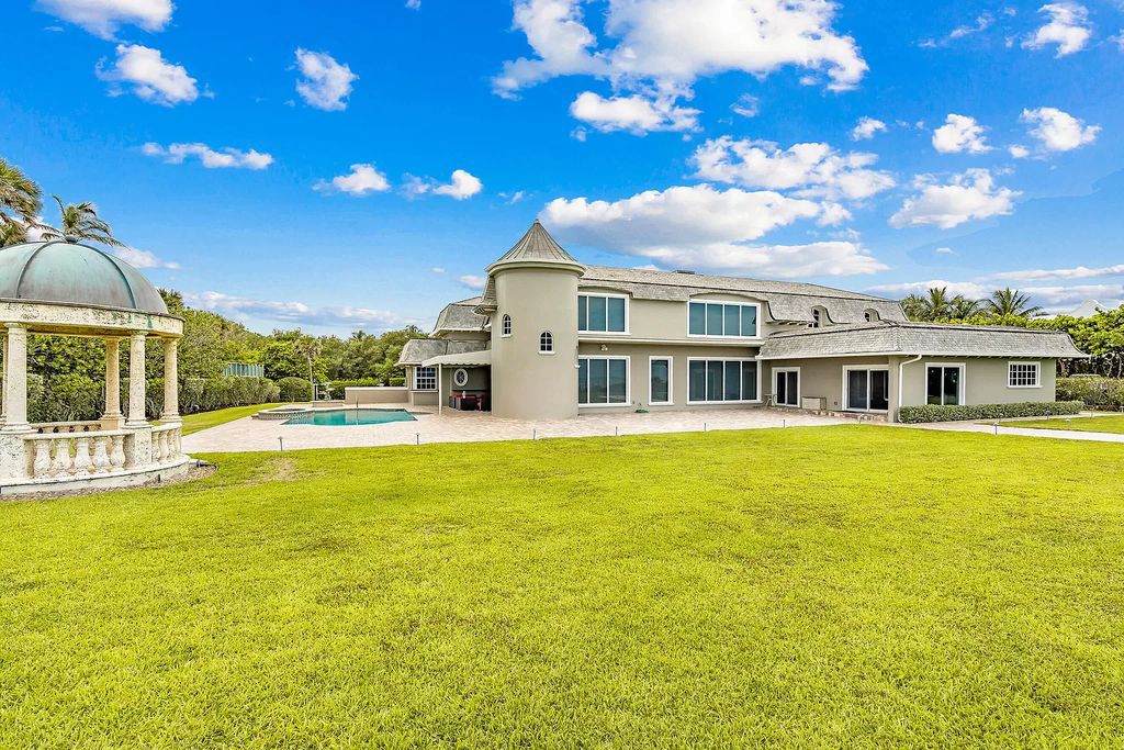 This captivating oceanfront estate on Jupiter Island offers 4 beds, 10 baths, and 2.62 acres of land with 242 feet of water frontage. Enjoy direct ocean views from every room in the house and spend your days swimming, sunbathing, and fishing.