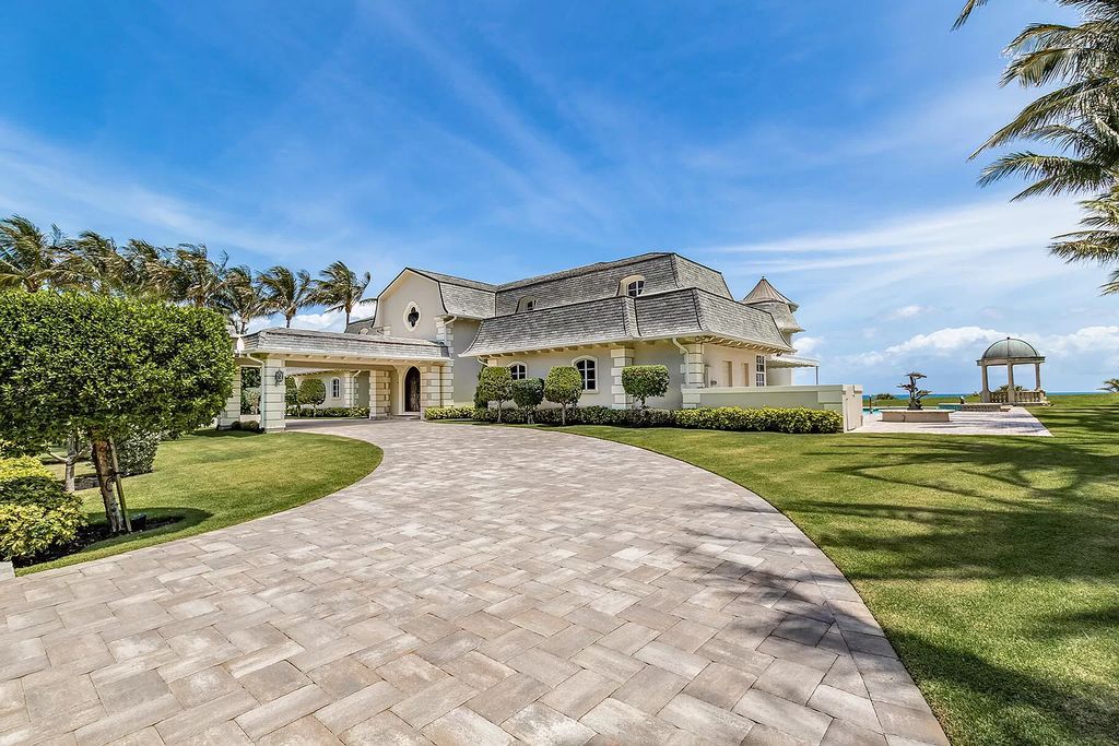 This captivating oceanfront estate on Jupiter Island offers 4 beds, 10 baths, and 2.62 acres of land with 242 feet of water frontage. Enjoy direct ocean views from every room in the house and spend your days swimming, sunbathing, and fishing.