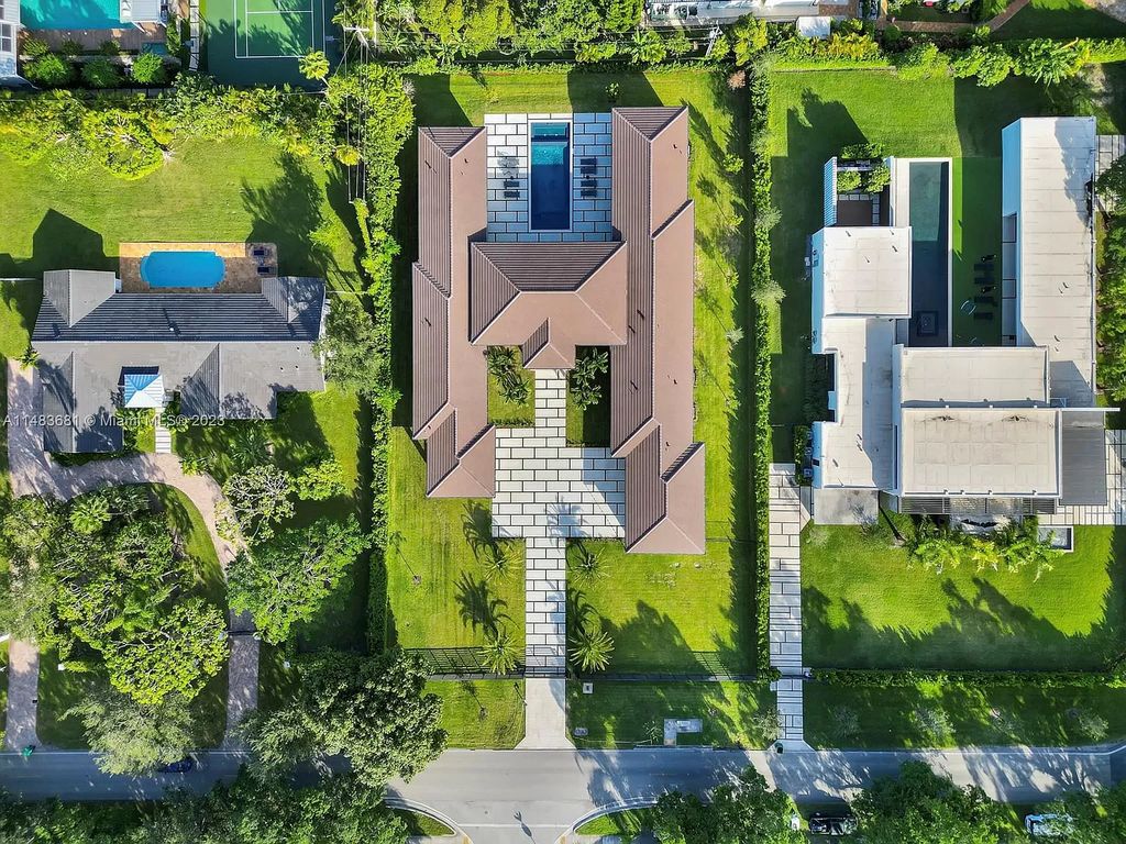 This stunning one-story transitional home in Pinecrest, FL features 7 beds, 8 baths, 6,720 sq ft of living space, and 0.88 acres of land. The home boasts high ceilings, natural lighting, and fine finishes throughout. The master suite features two walk-in closets, a floating tub, a rainfall shower with jets, and his and hers vanities and bathrooms. The custom Italian kitchen includes Sub-Zero appliances and a butler's pantry. The outdoor summer kitchen and terraces overlook the amazing pool. The home also has a 3-car garage and a carport for 2. This is the perfect Pinecrest home in a great neighborhood with excellent schools, parks, and retail nearby.