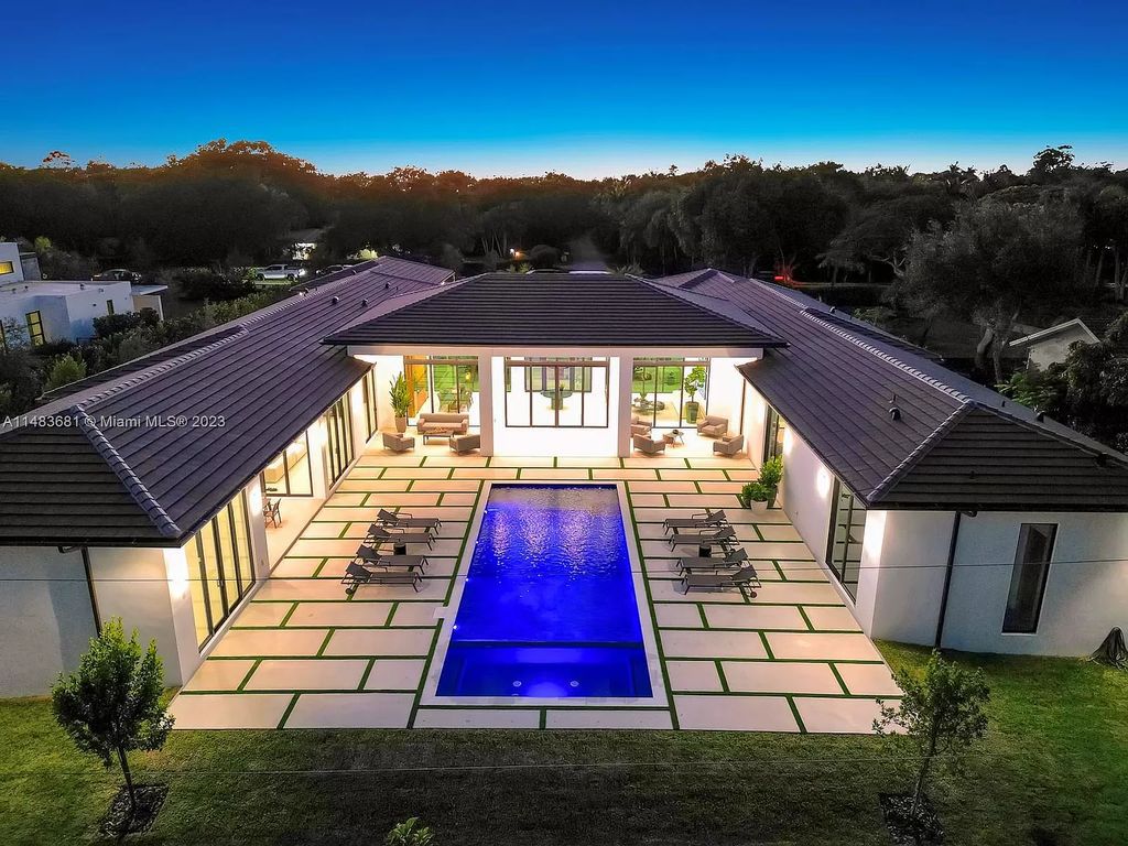 This stunning one-story transitional home in Pinecrest, FL features 7 beds, 8 baths, 6,720 sq ft of living space, and 0.88 acres of land. The home boasts high ceilings, natural lighting, and fine finishes throughout. The master suite features two walk-in closets, a floating tub, a rainfall shower with jets, and his and hers vanities and bathrooms. The custom Italian kitchen includes Sub-Zero appliances and a butler's pantry. The outdoor summer kitchen and terraces overlook the amazing pool. The home also has a 3-car garage and a carport for 2. This is the perfect Pinecrest home in a great neighborhood with excellent schools, parks, and retail nearby.