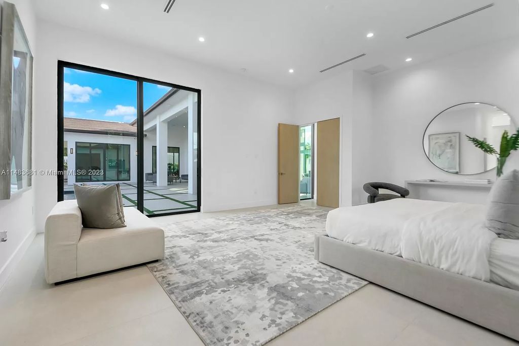 This stunning one-story transitional home in Pinecrest, FL features 7 beds, 8 baths, 6,720 sq ft of living space, and 0.88 acres of land. The home boasts high ceilings, natural lighting, and fine finishes throughout. The master suite features two walk-in closets, a floating tub, a rainfall shower with jets, and his and hers vanities and bathrooms. The custom Italian kitchen includes Sub-Zero appliances and a butler's pantry. The outdoor summer kitchen and terraces overlook the amazing pool. The home also has a 3-car garage and a carport for 2. This is the perfect Pinecrest home in a great neighborhood with excellent schools, parks, and retail nearby.