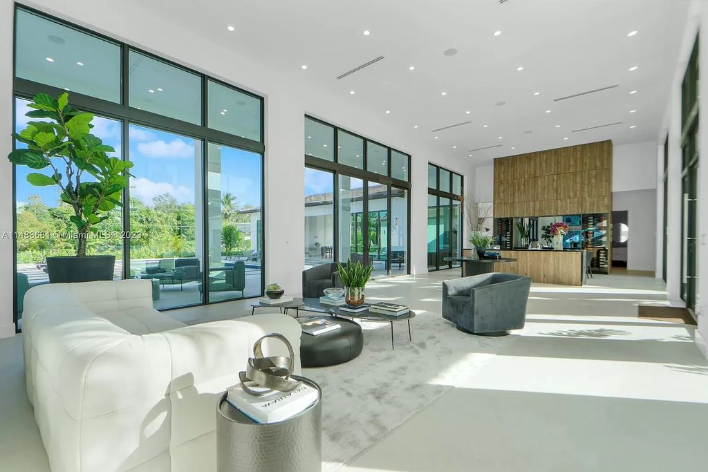 This stunning one-story transitional home in Pinecrest, FL features 7 beds, 8 baths, 6,720 sq ft of living space, and 0.88 acres of land. The home boasts high ceilings, natural lighting, and fine finishes throughout. The master suite features two walk-in closets, a floating tub, a rainfall shower with jets, and his and hers vanities and bathrooms. The custom Italian kitchen includes Sub-Zero appliances and a butler's pantry. The outdoor summer kitchen and terraces overlook the amazing pool. The home also has a 3-car garage and a carport for 2. This is the perfect Pinecrest home in a great neighborhood with excellent schools, parks, and retail nearby.