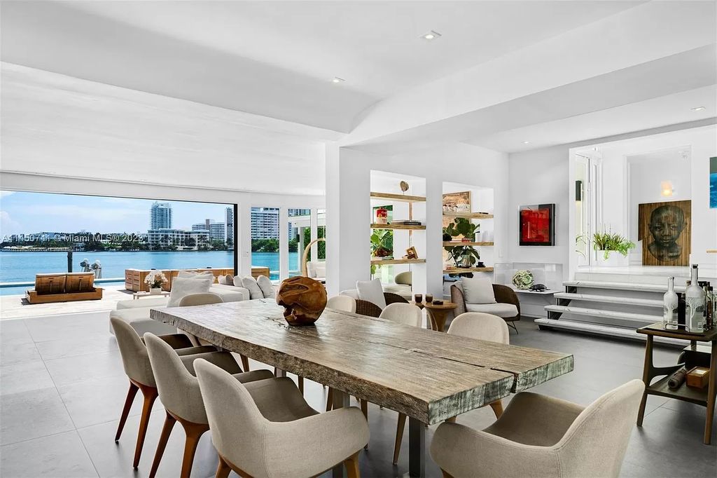 This magnificent waterfront property in Miami Beach, FL offers 90 feet of pristine water frontage, breathtaking views, and direct access to the beautiful waterways of Miami. The home features an open floor plan, a new summer kitchen with a Brazilian-style BBQ and pizza oven, gas fireplaces poolside and dockside, a custom 4-car garage, and more.