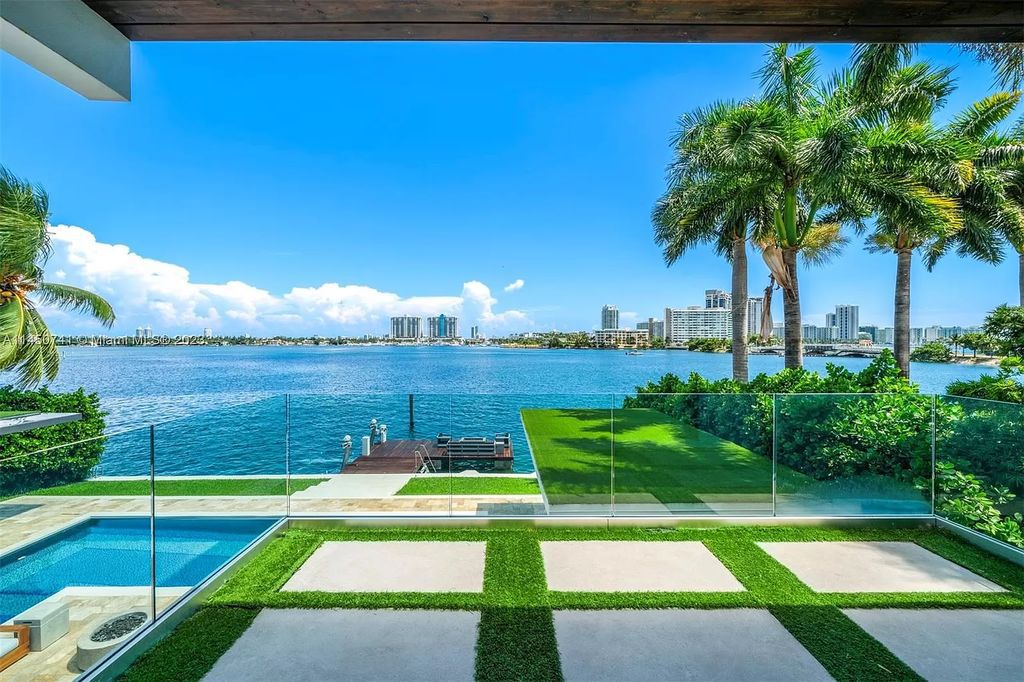 This magnificent waterfront property in Miami Beach, FL offers 90 feet of pristine water frontage, breathtaking views, and direct access to the beautiful waterways of Miami. The home features an open floor plan, a new summer kitchen with a Brazilian-style BBQ and pizza oven, gas fireplaces poolside and dockside, a custom 4-car garage, and more.