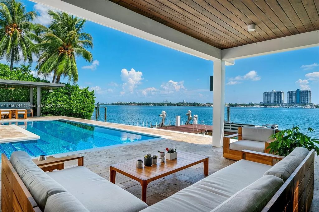 This magnificent waterfront property in Miami Beach, FL offers 90 feet of pristine water frontage, breathtaking views, and direct access to the beautiful waterways of Miami. The home features an open floor plan, a new summer kitchen with a Brazilian-style BBQ and pizza oven, gas fireplaces poolside and dockside, a custom 4-car garage, and more.