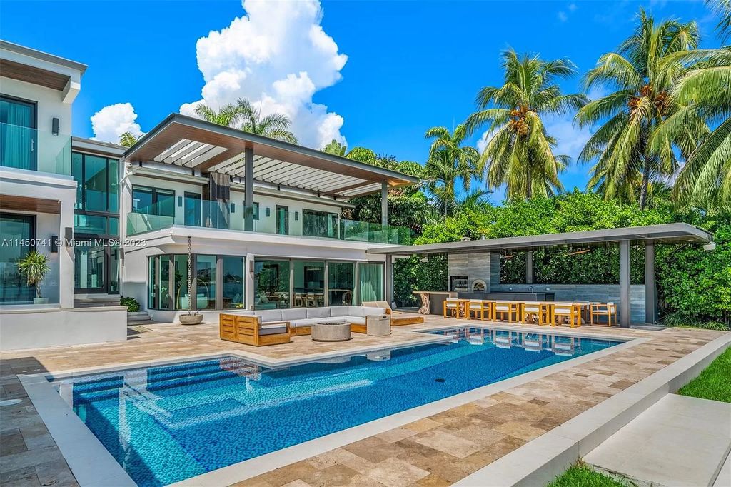 This magnificent waterfront property in Miami Beach, FL offers 90 feet of pristine water frontage, breathtaking views, and direct access to the beautiful waterways of Miami. The home features an open floor plan, a new summer kitchen with a Brazilian-style BBQ and pizza oven, gas fireplaces poolside and dockside, a custom 4-car garage, and more.