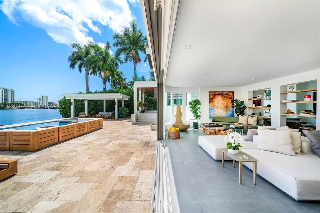 This magnificent waterfront property in Miami Beach, FL offers 90 feet of pristine water frontage, breathtaking views, and direct access to the beautiful waterways of Miami. The home features an open floor plan, a new summer kitchen with a Brazilian-style BBQ and pizza oven, gas fireplaces poolside and dockside, a custom 4-car garage, and more.